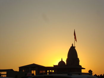 Silhouette temple against clear sky at sunset