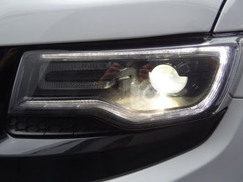 High angle view of reflection of illuminated car on mirror