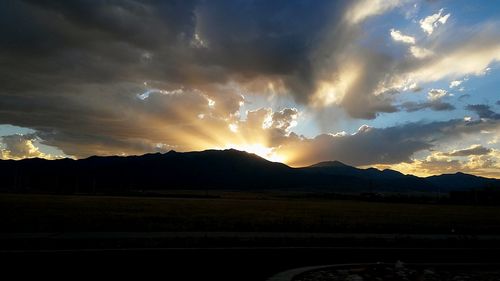 Scenic view of mountains against cloudy sky