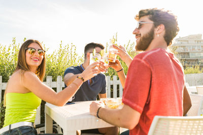 Happy young man drinking glasses