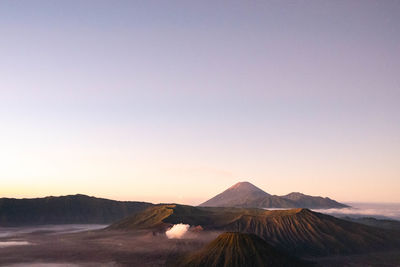 Scenic view of landscape against clear sky during sunset