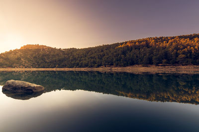 Scenic view of lake and mountains against clear sky