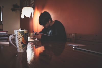 Side view of man working at table