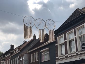 Low angle view of buildings in town against sky