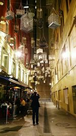 People walking in illuminated city