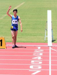 Full length of athlete standing on running track