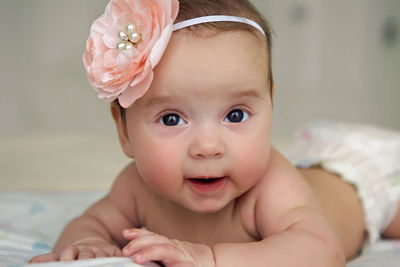 Baby girl lying on the bed in a diaper