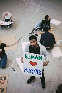 Portrait of male activist holding human rights poster