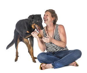 Woman with dog against white background