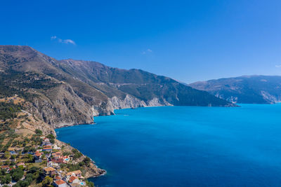 Scenic view of sea and mountains against sky