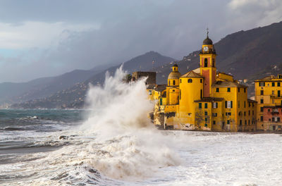 Scenic view of sea against buildings