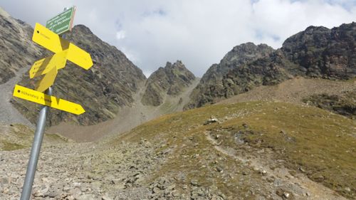 Road sign against mountain