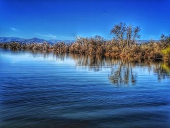 Scenic view of lake against blue sky