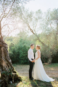 Rear view of bride standing in forest