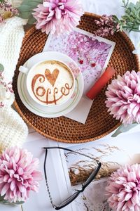 A cup of coffee, flower, sweater in flatlay still life