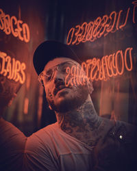 Close-up of man seen from glass with reflection