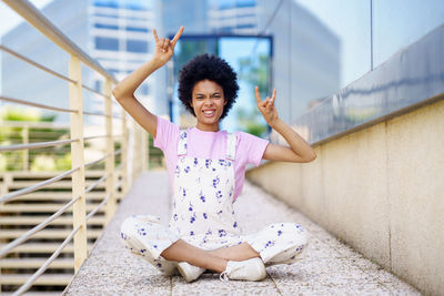 Portrait of young woman sitting on floor