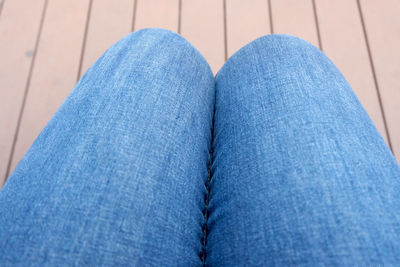 Low section of woman wearing canvas shoes