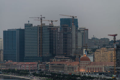 Buildings in city against clear sky