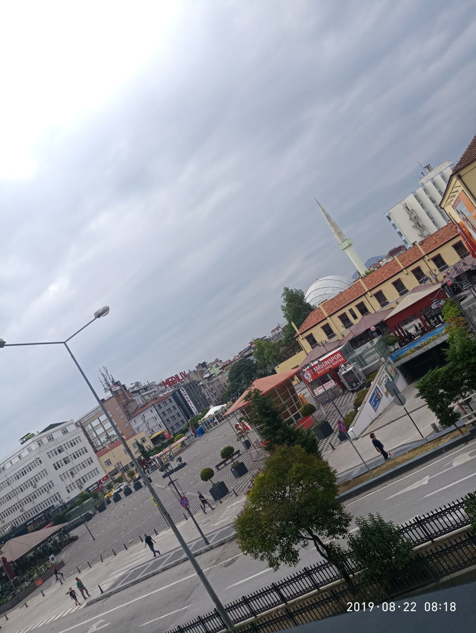 HIGH ANGLE VIEW OF CITY STREET AND BUILDINGS AGAINST SKY