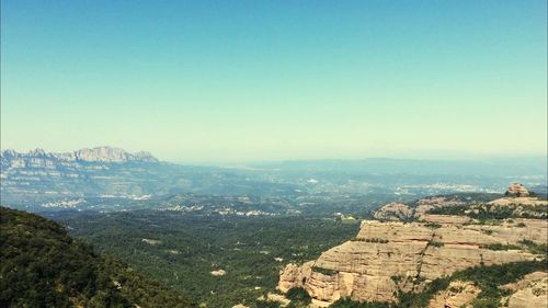 Scenic view of mountains against blue sky