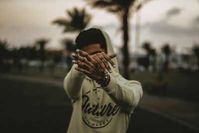 Portrait of young man standing on road