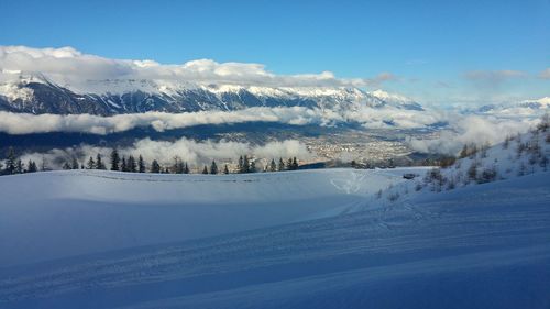 Scenic view of snow covered mountains against sky