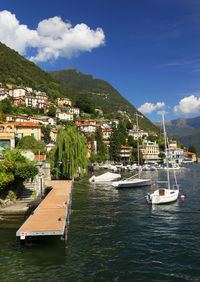 Boats in river against built structures