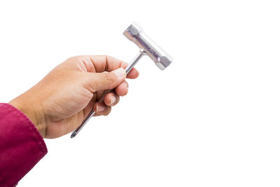 Close-up of hand holding crane against white background