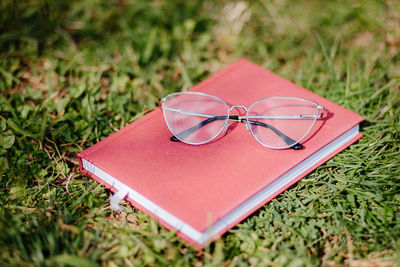 High angle view of eyeglasses on book