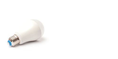 Close-up of light bulb over white background