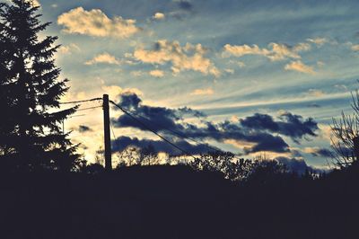 Low angle view of silhouette trees against sky at sunset