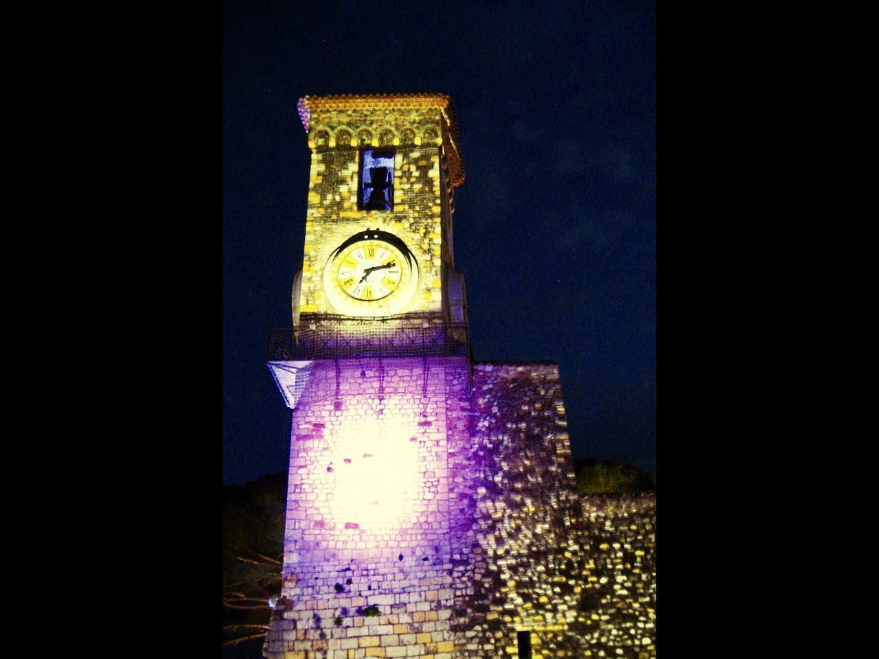 ILLUMINATED CLOCK TOWER AT NIGHT