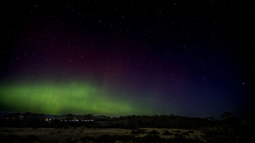 Scenic view of landscape against sky at night