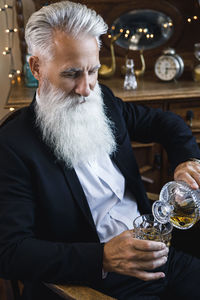 Portrait of senior woman drinking glass