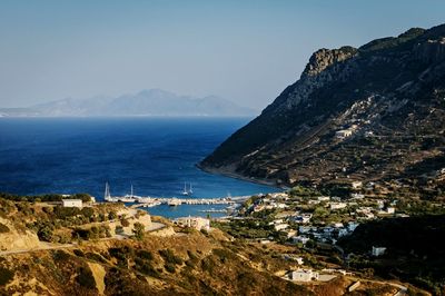 Scenic view of sea and mountains against clear sky