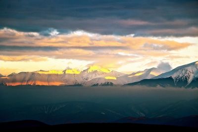 Scenic view of mountains against sky during sunset