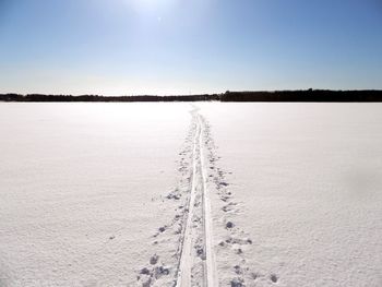 Scenic view of snow covered landscape against clear sky