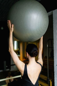 Rear view of woman standing at home