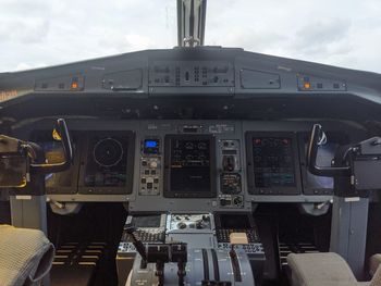 View of airplane at airport runway against sky