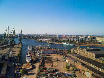 High angle view of buildings and sea against clear sky