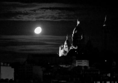 Illuminated city against sky at night