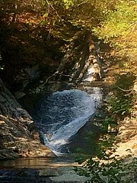 Stream flowing through rocky mountains