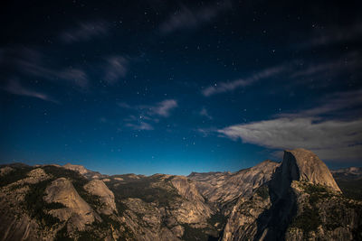 Scenic view of mountains against sky at night