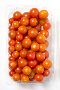 High angle view of cherry tomatoes over white background
