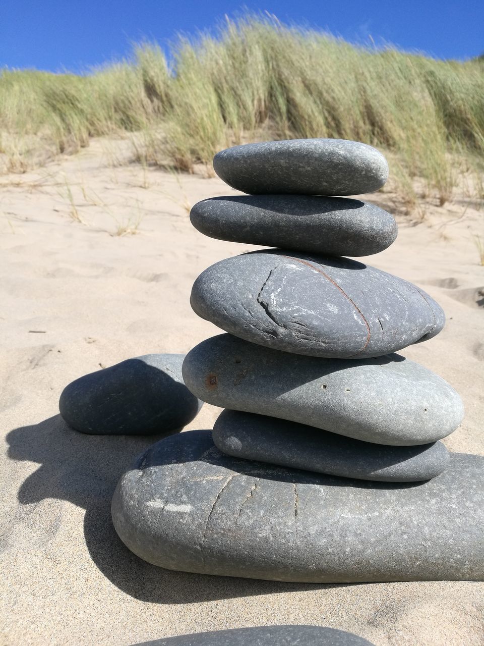 STACK OF PEBBLES ON BEACH