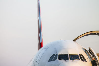 Low angle view of airplane flying against clear sky