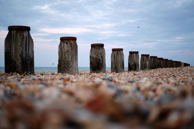 Rocks on beach against sky
