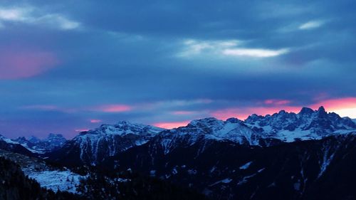 Scenic view of snowcapped mountains against sky during sunset