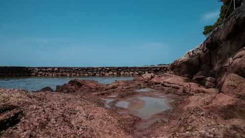 Rocks on beach against sky